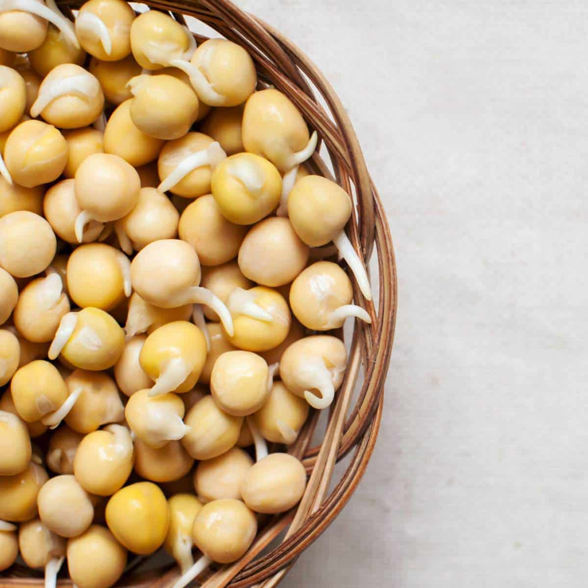 A wicker basket filled with yellow soybeans.