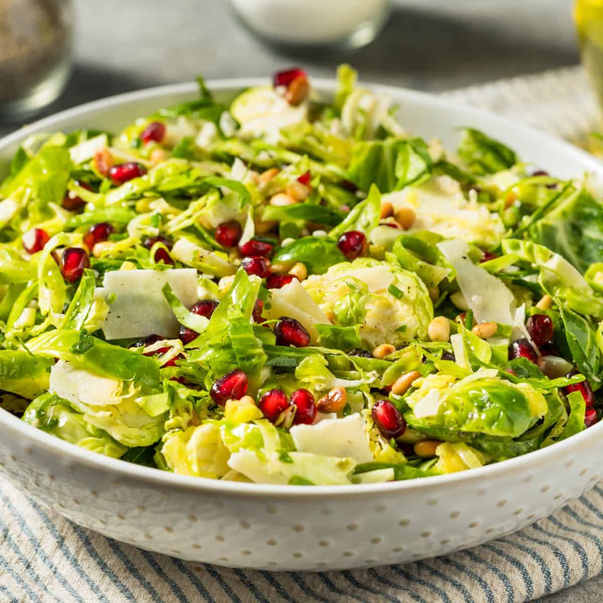 A bowl of brussels sprouts salad with pomegranate.