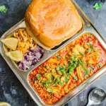 An indian meal in a tray on a table.